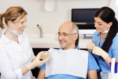 man happy with his new smile with the use of dental crowns 