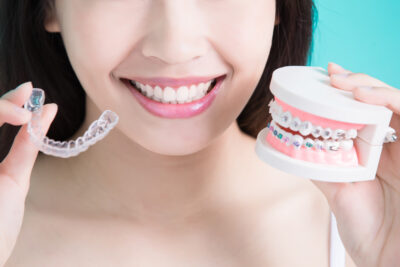 Invisalign vs. braces - young woman deciding on what's best