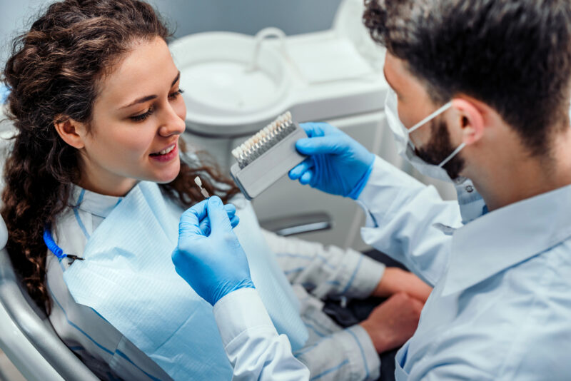 woman at dentist choosing all-on-4 dental implants for her missing teeth