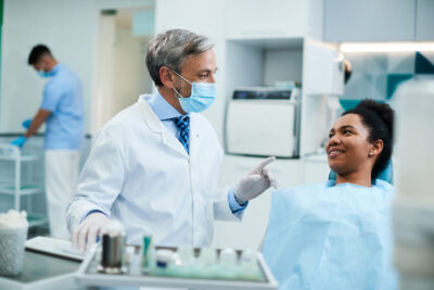 dentist treating woman for her dental implants