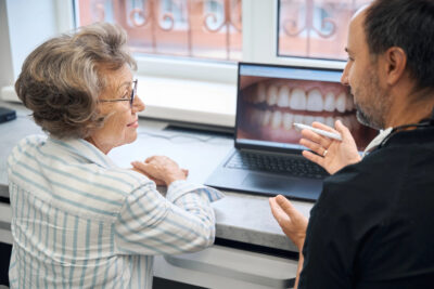 dentist discussing with patient if dental bridge procedure is right for her 