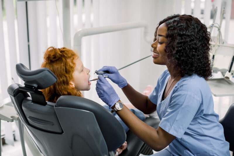 best pediatric dentist examining a child's teeth