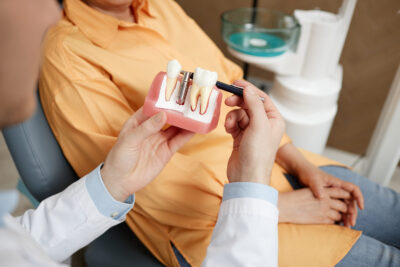 dentist showing patient the all on x dental implant procedure and what implants look like 