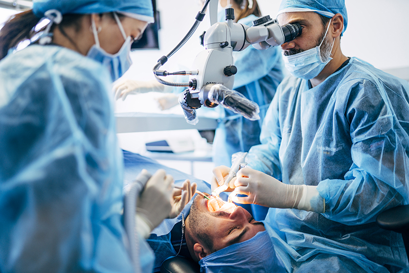 Team dental surgeons working in dental clinic.