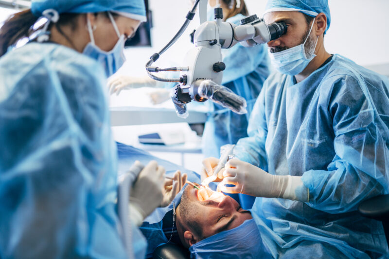 oral surgeon working on tooth transplant