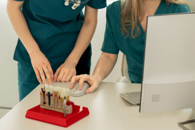 implantologist looking at computer ready to perform full arch dental implant procedure 