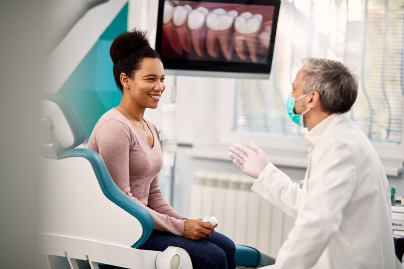 happy woman at a consultation for full arch dental implants