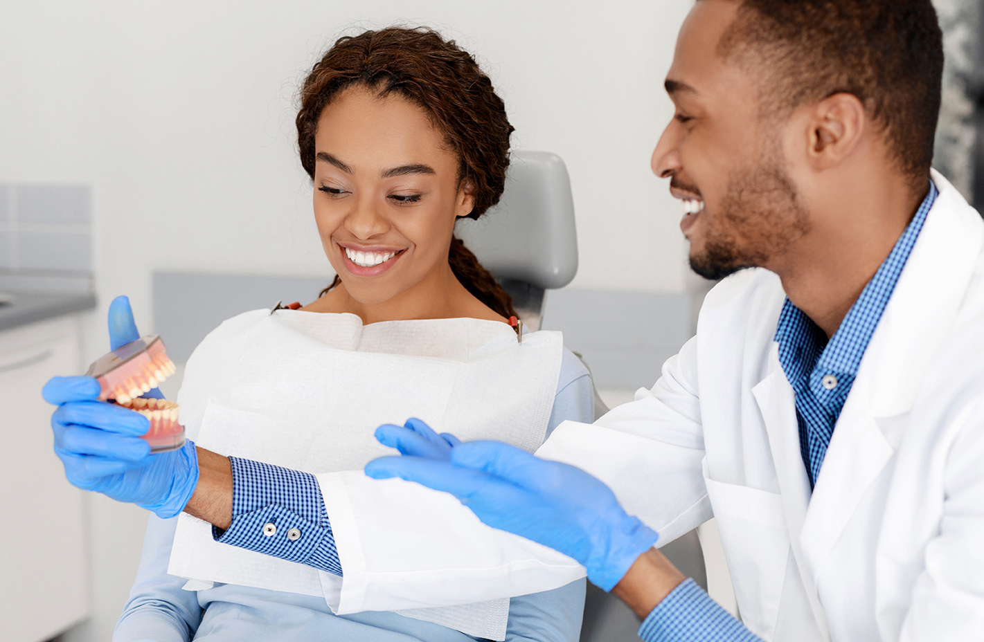 A dentist educating his dental patient