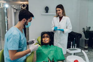 young woman receiving a consultation to see if she should get veneers or dental bonding 