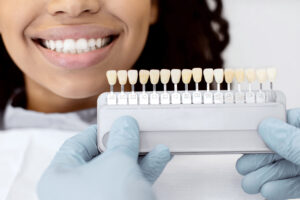 young woman choosing the right shade for her veneers 